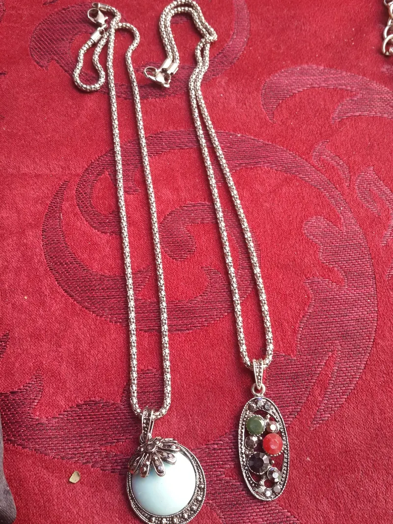 Two silver necklaces with colourful pendants