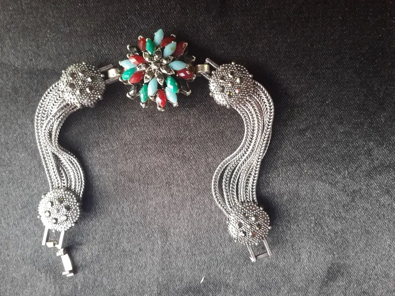 Silver bracelet with chains and a flower of stones