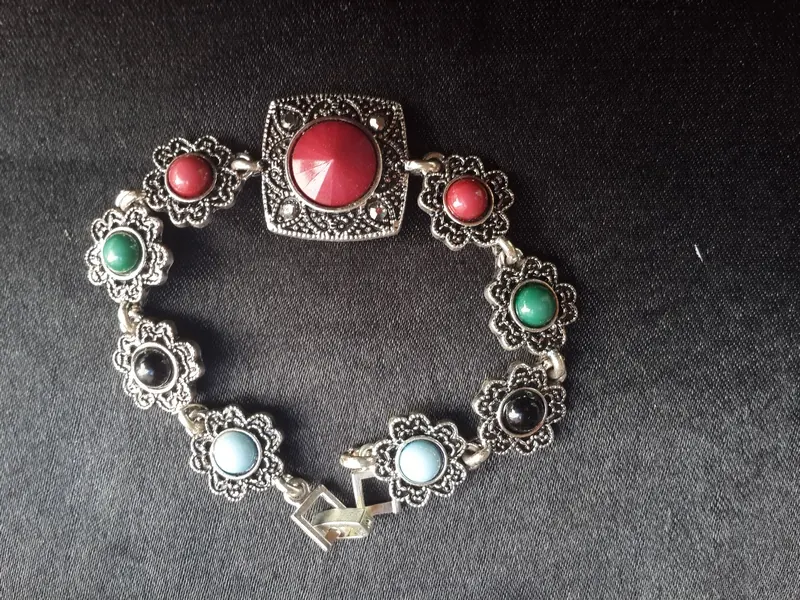 Silver bracelet with red and green stones