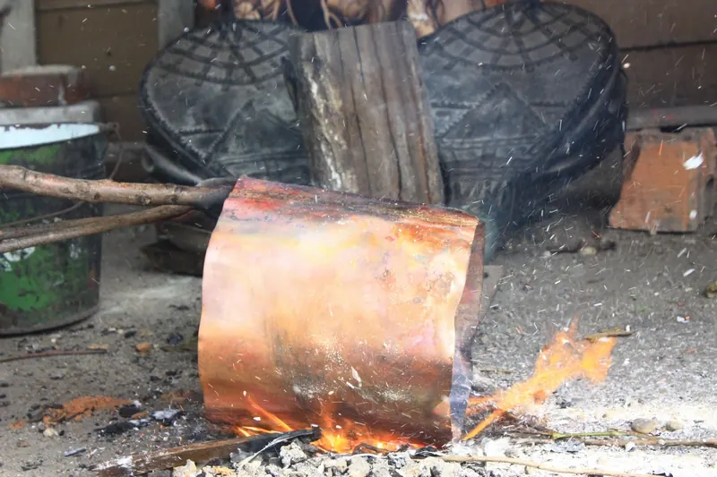 Copper sheet reddened by the flames