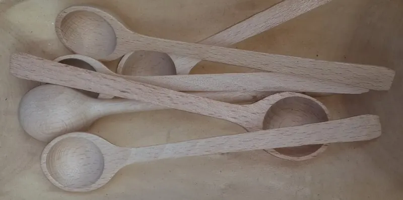 Hand-carved wooden spoons laid side by side